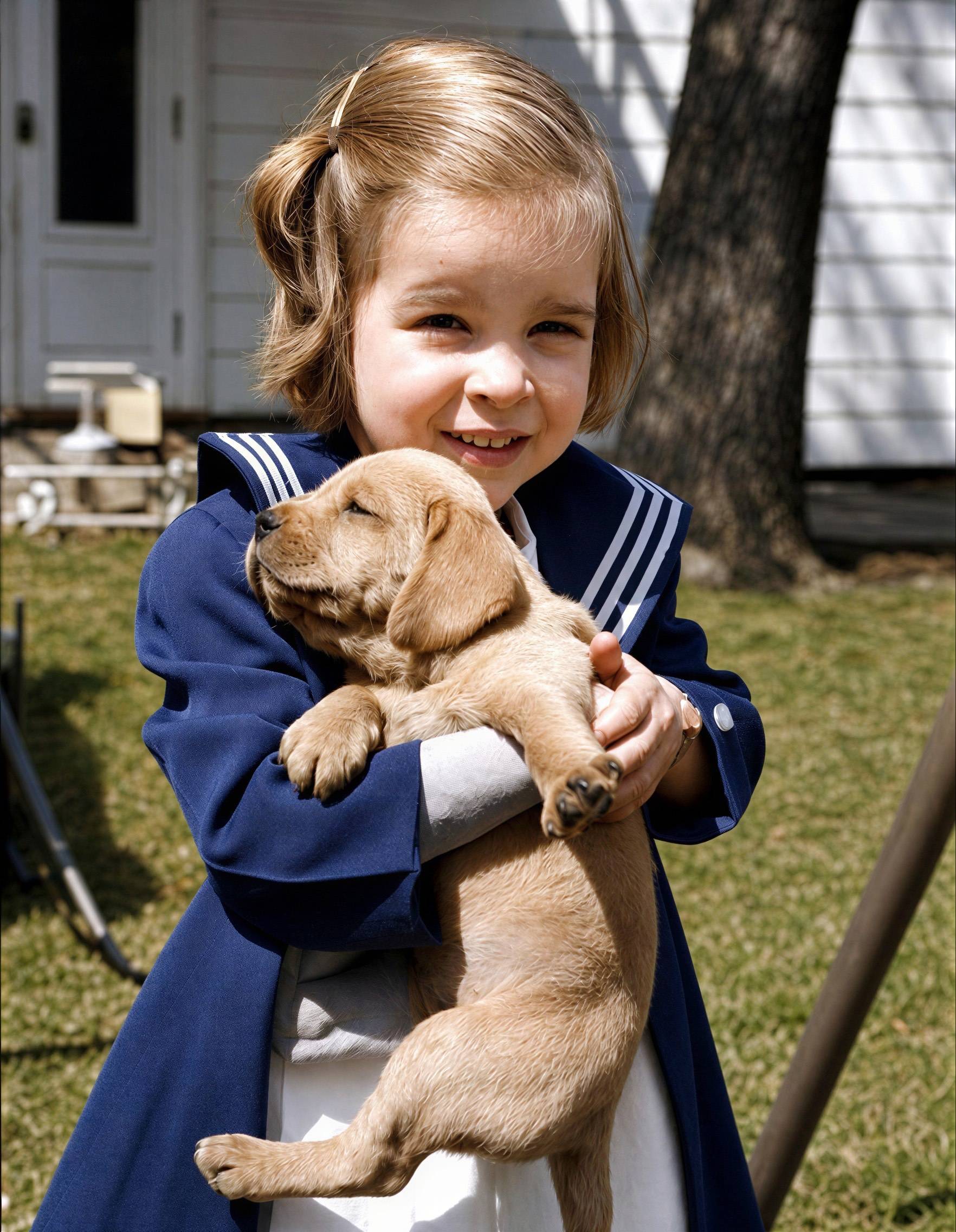 Restored and colorized photo of a girl with her puppy