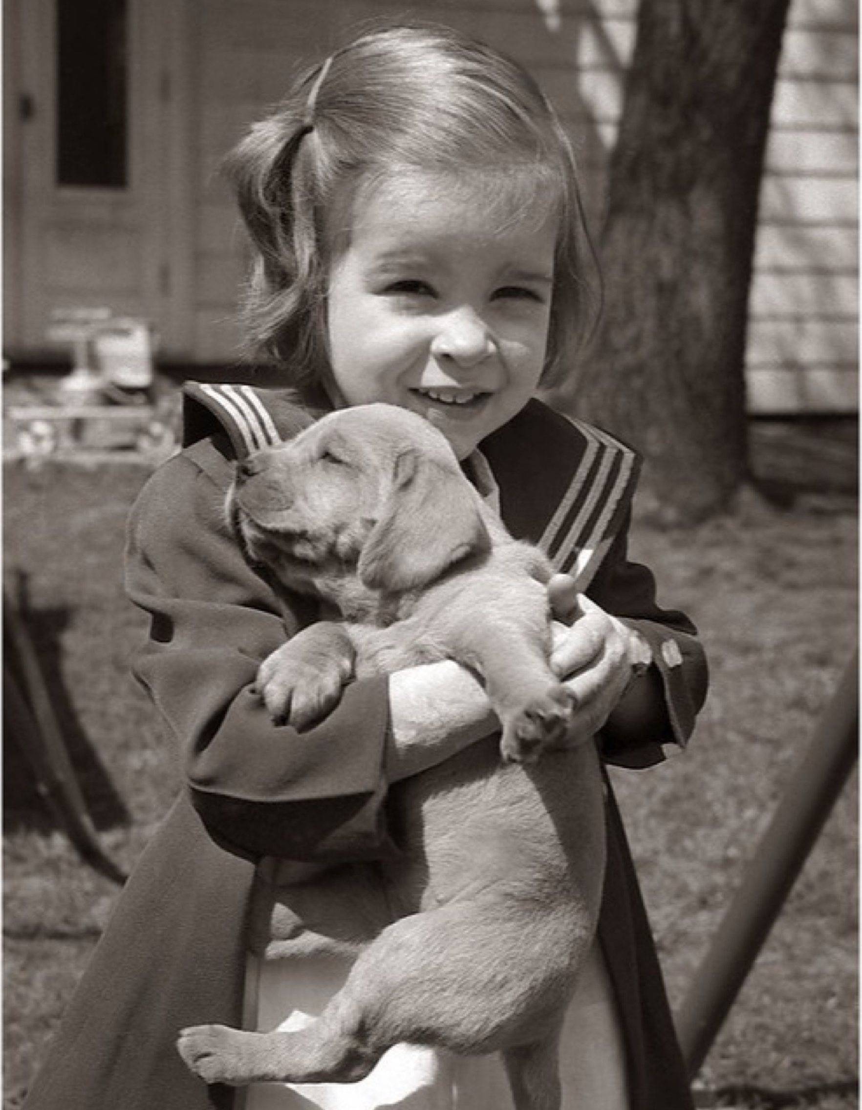 Original faded photo of a girl with her puppy